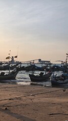 sunset atmosphere on a beach full of fishing boats