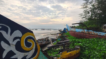 sunset atmosphere on a beach full of fishing boats