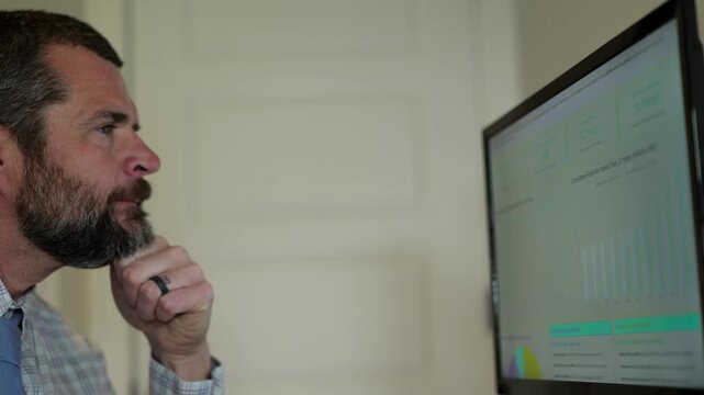 Middle Aged Business Analyst Reviews Clean Energy Conversion Executive Report from Home Office - Green Power Long Term Savings Concept