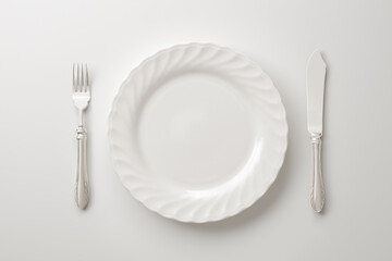 white plate, fork, and knife