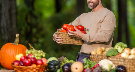 Agriculture crop. Farmer food market. Man farmer with tomato vegetable harvest. Organic food and eco farming. Greengrocer man outdoor. Greengrocer harvesting tomato. Autumn vegetable harvest banner