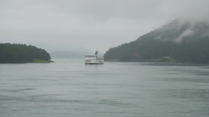 BC Ferry sailing past islands in coastal waters, British Columbia, Canada