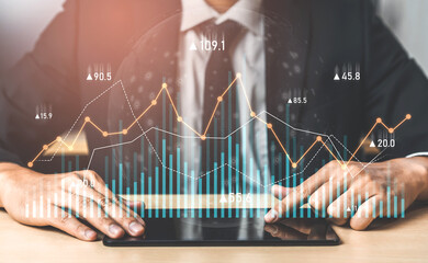 A businessman in a suit analyzes financial data trends displayed on a tablet, with dynamic graphs and statistics representing growth and insights in a modern office. Scalp