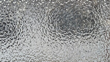 Blurred frosted glass texture. Window backdrop with shadows and reflections. Glass effect background. Abstract gradient bright light reflection and shiny rough texture surface