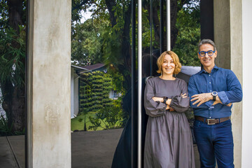 Smiling business partners posing with arms crossed