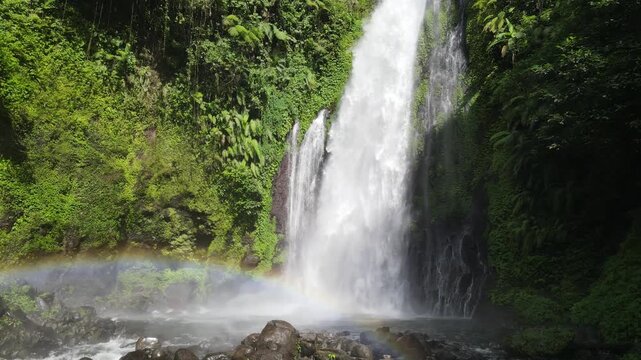 Aerial Footage of Gomblang Waterfall with Rainbow in Dense Forest, Java Island, Indonesia