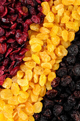 Dried cranberries and raisins background texture with sun dried golden raisins