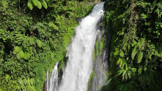 Aerial Footage of Gomblang Waterfall with Rainbow in Dense Forest, Java Island, Indonesia