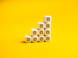 AI data icons on white cube stacked as graph steps on yellow background represent rapid growth of artificial intelligence data, data center expansion, big data trends, modern digital infrastructure.