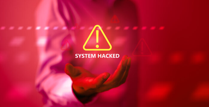 A cybersecurity alert concept showing a glowing warning icon and “SYSTEM HACKED” text on a red background, representing cyber attacks, system breaches, digital threats, and data security risks.