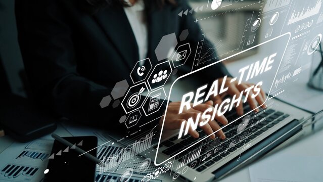 Business professional working on laptop with digital interface showcasing real-time insights and data analysis concepts in modern workspace. Asymptotic smart data analytic. - Powered by Adobe