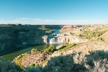 Landscape view of Shoshone Falls as seen from downriver along the edge of the Snake River canyon. Taken in the Shoshone Falls Scenic Area, a public park that includes the waterfall in Twin Falls, ID.