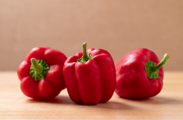 Fresh red bell pepper or sweet pepper on wooden background