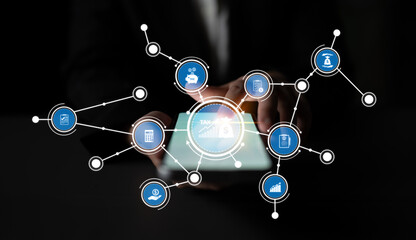 A person holds a digital tablet displaying various business icons connected through data links, symbolizing the integration of technology and information in a professional setting. Crux