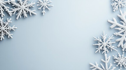 Snowflake silhouette arrangement on pale blue background conveying winter calm