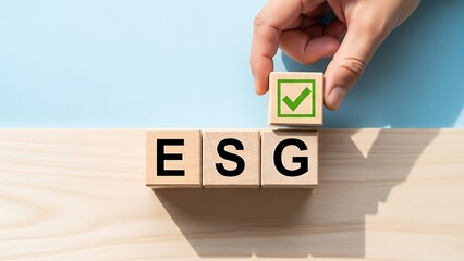 Naklejka premium ESG concept with wooden blocks and a hand placing a checkmark block.