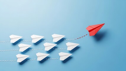 Leadership concept with red paper airplane leading white ones on blue background.