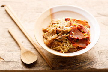 Egg Noodles with meat in bowl with chopsticks
