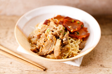 Egg Noodles with meat in bowl with chopsticks