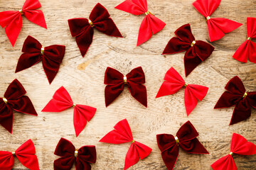 Red ribbons on wooden background. Christmas decorations concept.