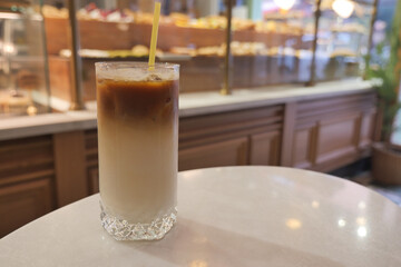 Coffee drink sits on a table in a cafe during the day