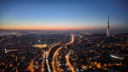 Naklejka premium City skyline at sunset with lights and tall tower visible in istanbul 