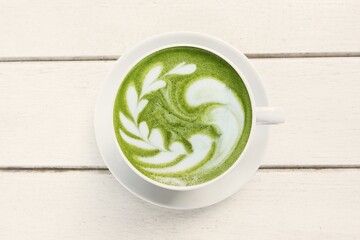 A cup of green tea matcha latte on white wooden background                                                                                                                                              