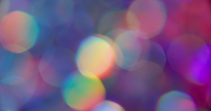 Blur circles. Neon light. Purple pink orange colorful lens flare rainbow round texture glisten on abstract vibrant bokeh background. - Powered by Adobe