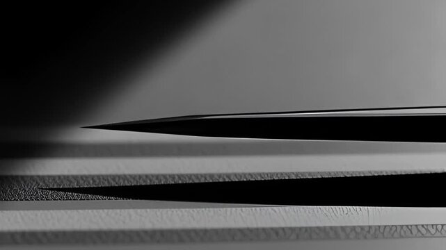 Abstract close-up of a sharp pointed object casting a dramatic elongated shadow on a textured surface emphasizing contrast and precision