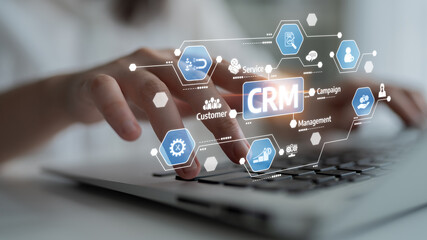 Engaging image depicting a hand interacting with a laptop, illustrating a modern CRM system with...