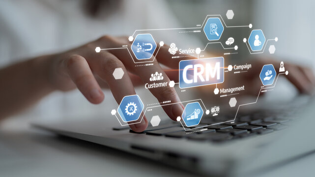 Engaging image depicting a hand interacting with a laptop, illustrating a modern CRM system with digital icons representing various aspects of customer management and engagement. Tessel - Powered by Adobe