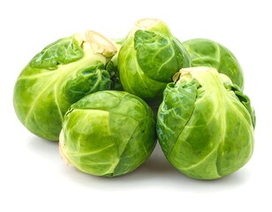 Close-up studio shot of several small, round, green vegetables piled together against a plain white background. The leaves are visible