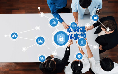 A diverse team collaborates on a cybersecurity strategy, using puzzle pieces to symbolize connection and protection in a digital workspace, fostering teamwork and innovation. Amity