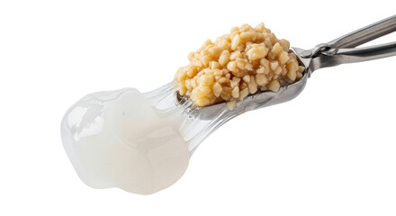 Scoop of molecular gastronomy pearls resting with a gelatinous mass, showcasing culinary science with delicate textures and contrasts against a