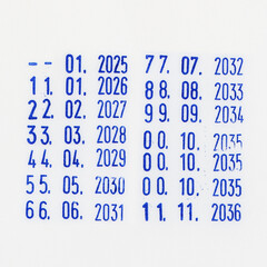 Dater Stamp blue marks with dates and years from 2025 to 2036 stamped on white background.