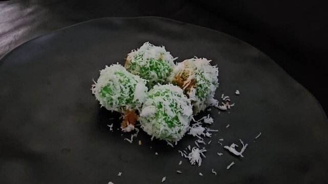 stir fried vegetablesKlepon or Kelepon or Kalalapun or Onde onde or Buah melaka or Kuih melaka is a sweet rice cake ball filled with molten palm sugar,coated in grated coconut,the green colored glutin