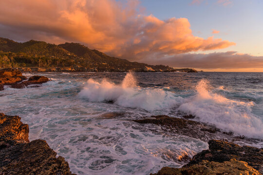 Sunset Rocky Coast - A panoramic sunset view of strong waves rushing towards rocky shore. Point Lobos State Natural Reserve, Monterey, California, USA.