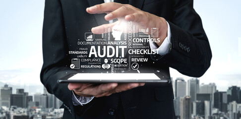 A business professional stands with a tablet, focusing on audit processes and compliance standards, highlighted by a bustling city skyline, symbolizing modern business dynamics. Tessel