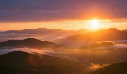 Obraz premium Golden Sunset Over Majestic Mountain Layers With Soft Misty Horizon