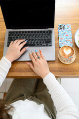 young woman working on laptop in  cafe