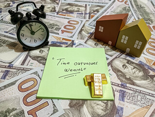 A conceptual image featuring a clock, gold bars, houses, and dollar bills with a note saying...