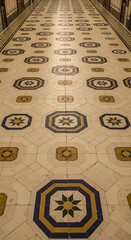 Intricate patterned floor stretching into distance provides a sense of depth