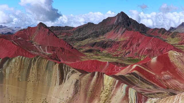 Rainbow Mountain Vinicunca Palccoyo Monta&ntilde;a de Siete Colores Peru aerial drone Peruvian Andes Red Valley striped hills morning cblue sky clouds seven colored Vilcanota Cusco Region parallax circle