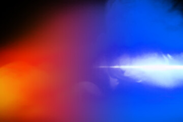 colorful smoke on dark background. Color steam on a black background. Red and blue smoke. Copy space.