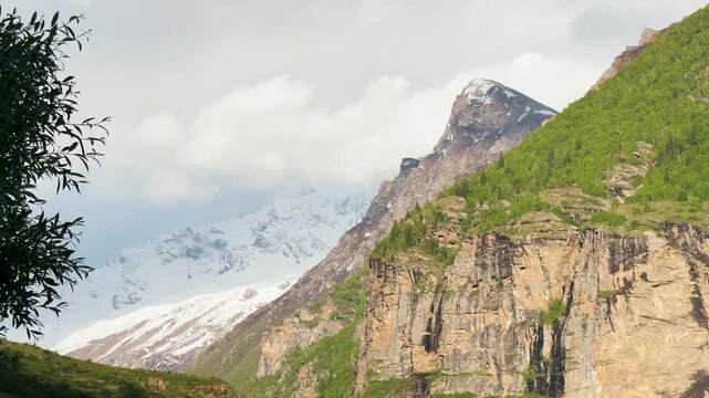 4K Landscape shot of clouds above the snowy Himalayan mountain range during the winter season as seen from Hudan Bhatori in Pangi Valley, Chamba, Himachal Pradesh, India. Scenic Himalayas in winter.