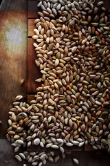 Roasted salted pistachios. Dried pistachios in small sack on  table.