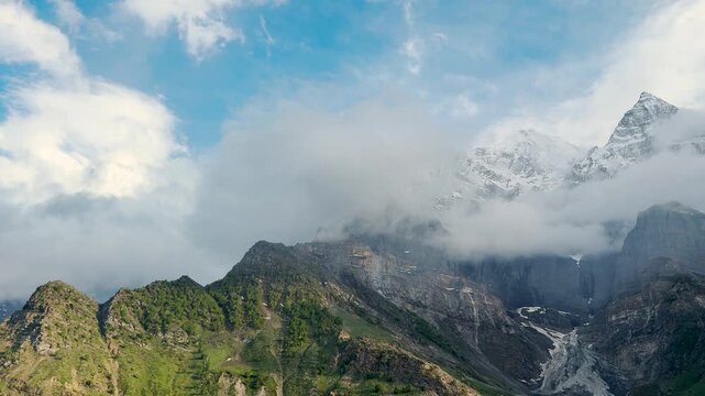 4K Landscape shot of clouds under the snowy Himalayan mountain peak after winter storm during evening as seen from Khangsar village in Lahaul and Spiti district, Himachal Pradesh, India. Nature view.