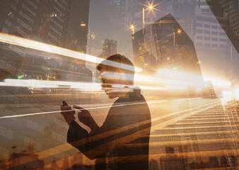 Urban Motion: Double Exposure of Man Using Smart Phone and City Lights
