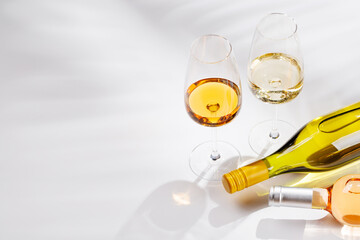 Naklejka premium Different wine bottles and glasses on white background