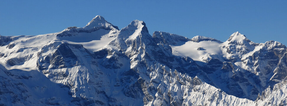 Snow covered Uri Rotstock, high mountain in Central Switzerland.